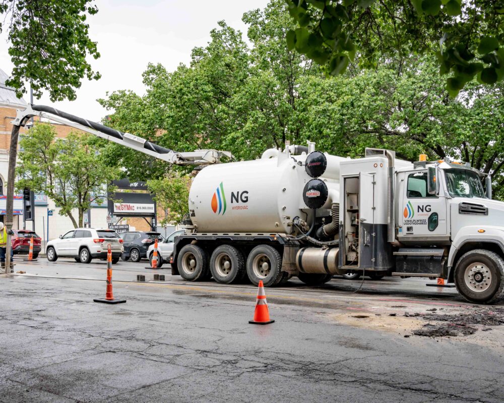 NG Companies employee using hydrovac on the street
