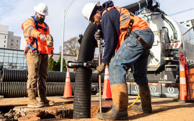 ng workers performing hydrovac excavation on utility emergency