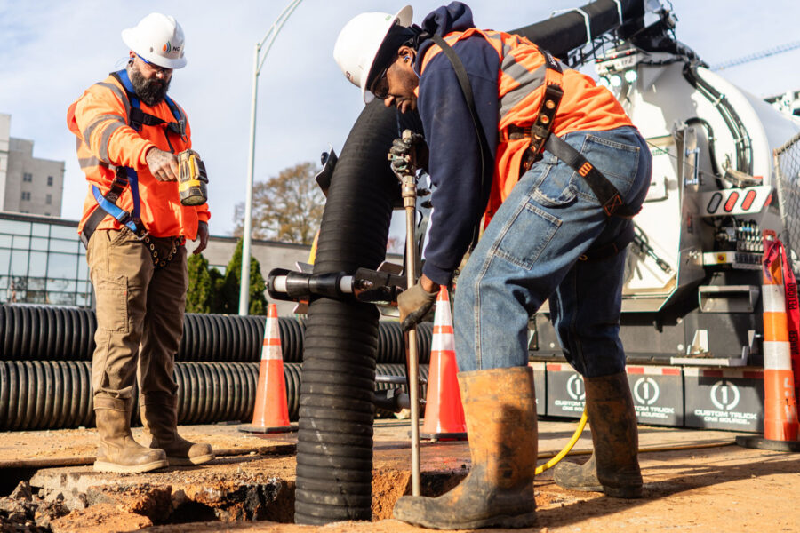 ng workers performing hydrovac excavation on utility emergency